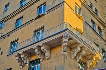 A large balcony in a residential building of old architecture and design.