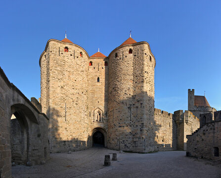 Porte Narbonnaise city gate at the rampart wall of Carcassonne with its moat, towers and Aude department in France