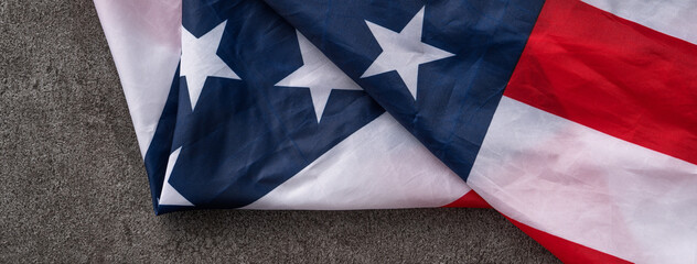 Concept of Independence day or Memorial day. Flag over dark gray table background.