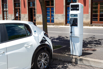 Fototapeta premium electric car charging at a modern gas station