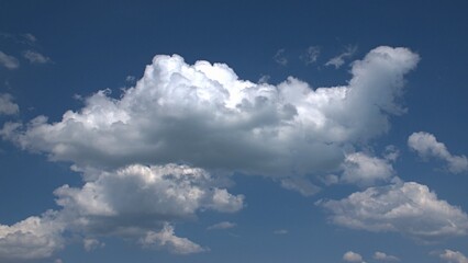 Beautiful fluffy white clouds float across the blue sky. Background. Banner. Screensaver on the monitor.
