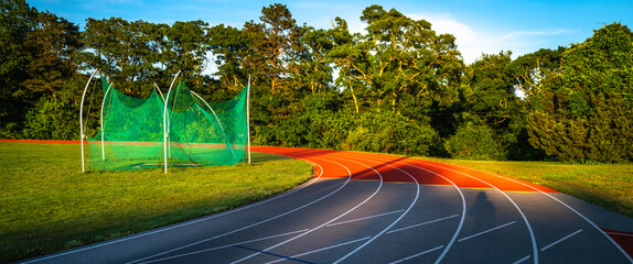 Track and field with curved lines and green nets
