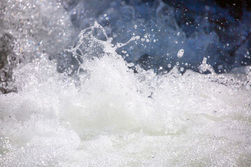 Drops of water, splashing and bubbling waterfall as a background. Foam party or laundry. The...