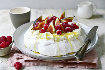 Homemade delicious meringue cake "Pavlova" with figs and fresh raspberry .