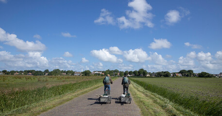 Cyclists at road to village. Schiermonnikoog waddeneiland. Netherlands. Waddenzee. Coast