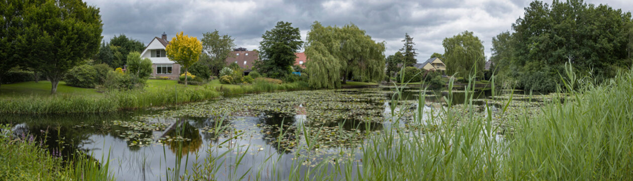 Pond at village Uffelte Drente Netherlands.  Countrylife. Panorama. Houses at lake.