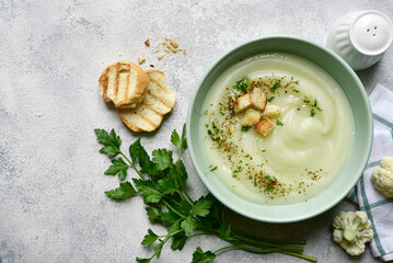 Vegetarian cauliflower cream soup with croutons. Top view with copy space.