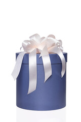 Blue round box with a white bow on an isolated white background.