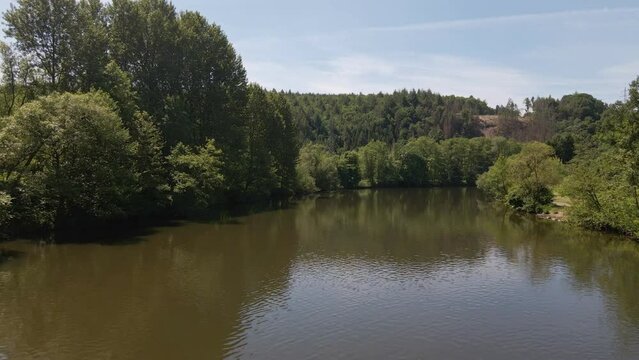 Calm expansive river in west Germany on a sunny spring morning. Wide angle flyover