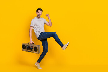 Full length body size view of attractive cheerful guy dancing listening music isolated over shine...