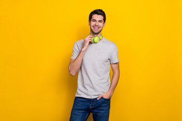 Photo of nice brunet millennial guy wear headphones trend cloth isolated on yellow color background