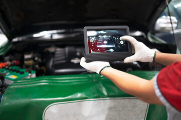 Professional mechanic and check car engine with computer diagnostic software.Expertise mechanic...
