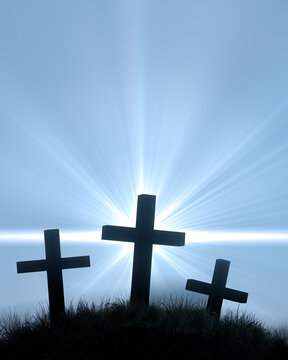 Three crosses on a grassy hill blue sky sunburst god rays