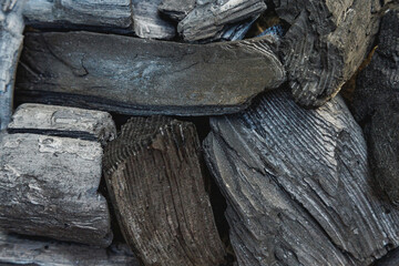 Black charcoal texture background. Close-up