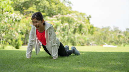 Healty Young female workout exercise before running or fitness training session in City Park. Healthy young woman warming up outdoors. She is stretching her arms at Garden park, Sports and activities