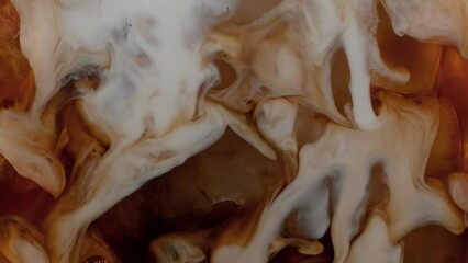 Super Slow Motion Shot of Pouring Cream into Ice Coffee at 1000 fps.