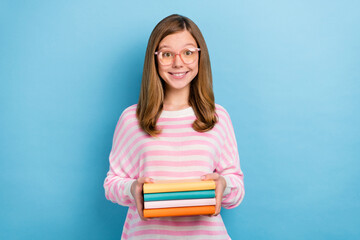 Portrait of positive cheerful girl hold pile stack book toothy smile isolated on blue color background