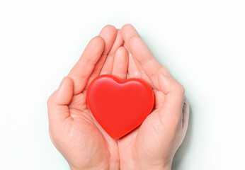 Red heart in hands on white background. Healthcare and hospital medical concept,organ donation concept.Symbolic of Valentine day.Heart day.Сopy space.