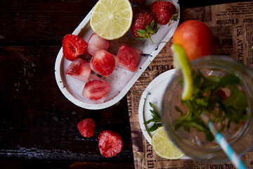 Summer infused water with lemon, lime, mint and strawberry ice. Refreshing, diet, detox natural fortified water. Hard seltzer with nootropics. Healthy natural cocktails. Summertime beverages.