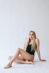 Naklejka premium Vertical Portrait of Blonde Woman with Long Legs. Underwear advertisement. Depilation concept. Copy Space.