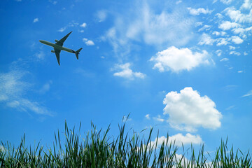 Silhouette of airplane flying in vibrant blue sunny sky