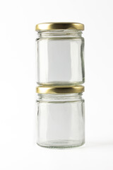 Two transparent glass jar for pickle and sauces on white background