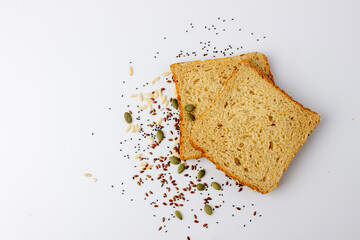 Healthy tasty multigrain bread with pumpkin, chia, flax seeds on white background