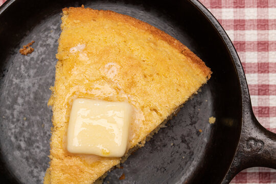 Cornbread ina cast iron skillet with melting butter