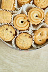 Top view tasty danish butter cookies in a tin box , set of crispy shortbread biscuits, baked pastry, sweet food, space for text.