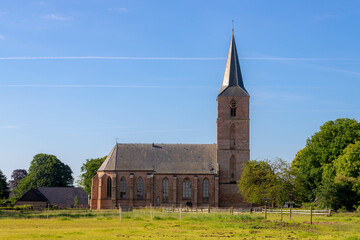 Countryside landscape with view of Jacobuskerk church and tower with green grass meadow, Located in...