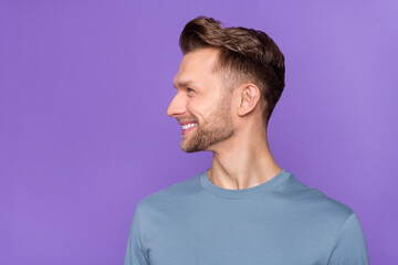 Fototapeta premium Profile photo of impressed brown hairdo guy look promo wear blue shirt isolated on violet color background
