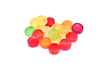 Multicolor round gummy candies on white background.