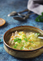 A bowl with chicken soup with pasta