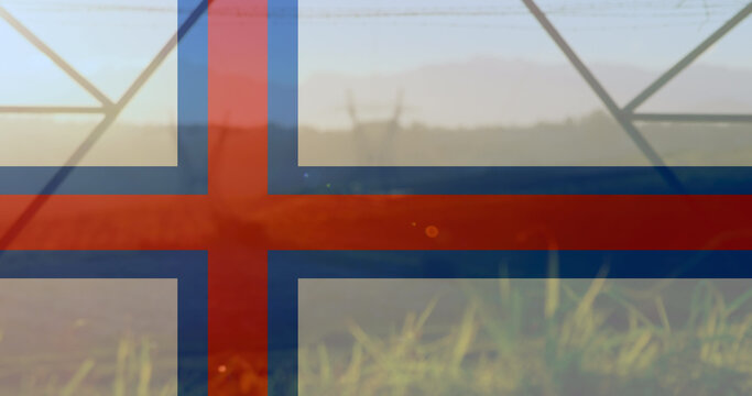 Image of flag of faroe islands over pylons - Powered by Adobe