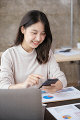 Young business woman discussing work via smartphone with happy face.