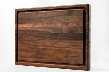 Brown wood cutting board on a white background