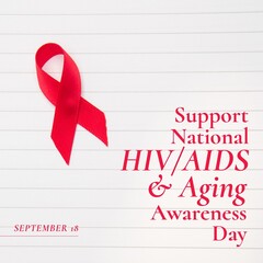 Red ribbon with support national hiv aids and aging awareness day text on lined paper, copy space - obrazy, fototapety, plakaty