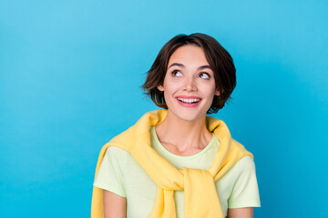 Fototapeta premium Photo of impressed young brunette lady look empty space wear yellow t-shirt isolated on blue color background