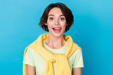 Photo of nice millennial brunette lady lick teeth wear yellow t-shirt isolated on blue color background