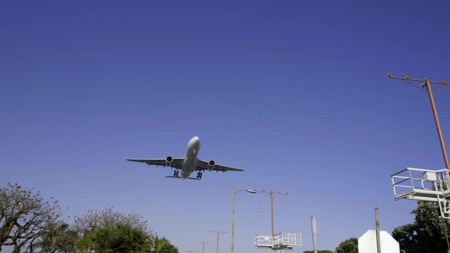 A Passenger planes flies above the camera and then lands at Los Angeles International Airport.
