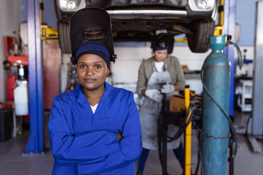 Portrait of confident mid adult female african american welder wearing protective workwear