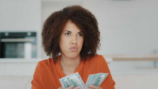 Thoughtful Pensive Wealthy African American Businesswoman Counting Dollar Salary Credit From Bank Cash Thinks About Finance Spending At Home Biracial Girl With Curly Hair Counts Money Financial Saving