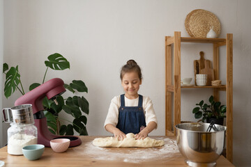 Cute Little Girl Kneading Dough On Table