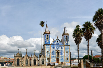 Fototapeta na wymiar chapel of the cemetery and the facade covered with azulejos of the church Santa Marinha in Cortegaca, Ovar district, Portugal