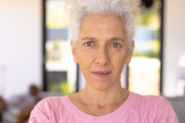 Close-up portrait of confident caucasian senior woman with gray eyes in nursing home