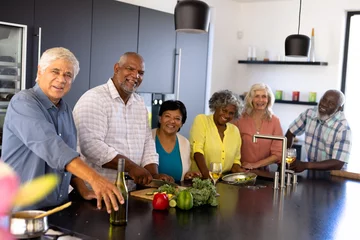 Poster Portrait of happy multiracial senior friends making lunch on kitchen island at nursing home © WavebreakMediaMicro