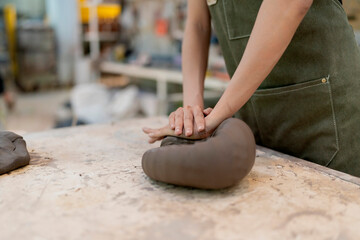 Asian Young woman female artist wear apron making clay vase bowl Beautiful young sculptor creates a...