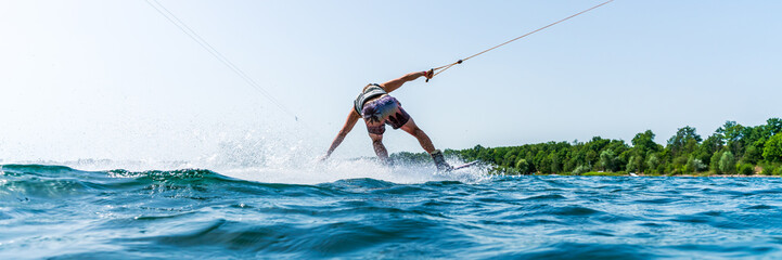Naklejka premium An athlete wakeboarding on a lake