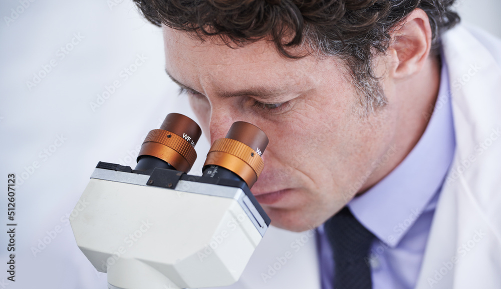 Poster Life under the microscope. A scientist observing something through a microcope.