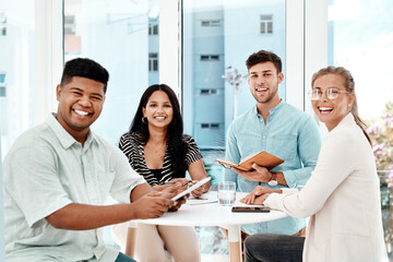 Fototapeta premium Were the team you need. Cropped portrait of a group of young business colleagues gathered around a table in their office.
